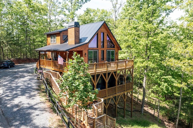 681 Confederate Cir, Murphy, NC 28906 - rear view of house featuring driveway, a chimney, metal roof, and a forest view
