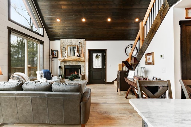 681 Confederate Cir, Murphy, NC 28906 - living area with wood ceiling, a stone fireplace, stairway, and light wood-type flooring