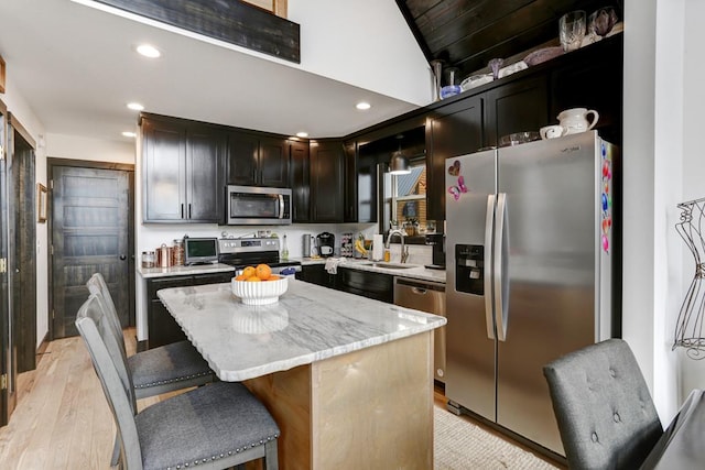 681 Confederate Cir, Murphy, NC 28906 - kitchen with a breakfast bar area, a center island, stainless steel appliances, light wood-style floors, and recessed lighting