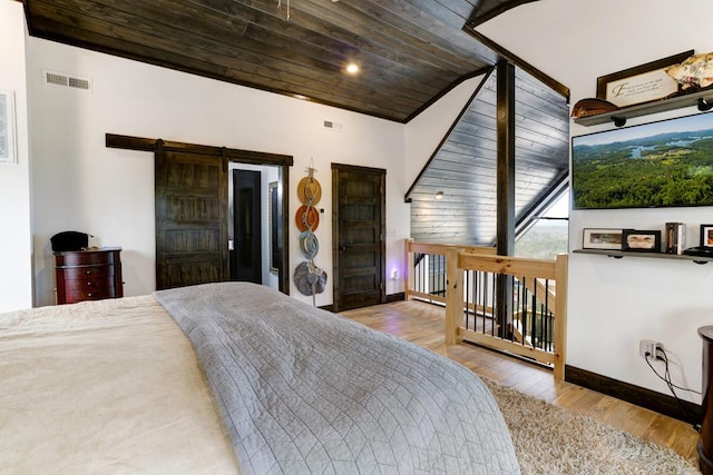681 Confederate Cir, Murphy, NC 28906 - bedroom featuring wooden ceiling, baseboards, a barn door, visible vents, and wood finished floors