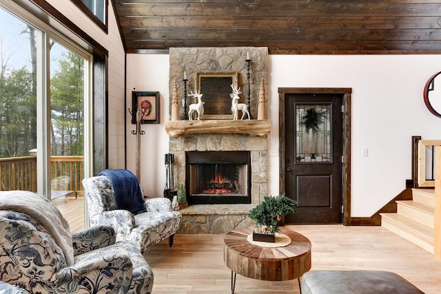 681 Confederate Cir, Murphy, NC 28906 - living room featuring a stone fireplace, lofted ceiling, stairs, and wood finished floors