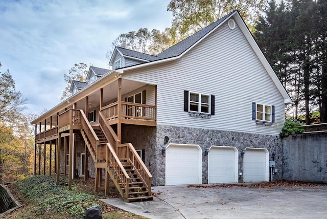 exterior space featuring a garage and a wooden deck