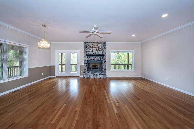 unfurnished living room featuring crown molding, a healthy amount of sunlight, and dark hardwood / wood-style floors