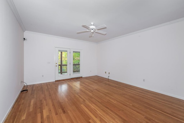 spare room featuring ceiling fan, wood-type flooring, and crown molding