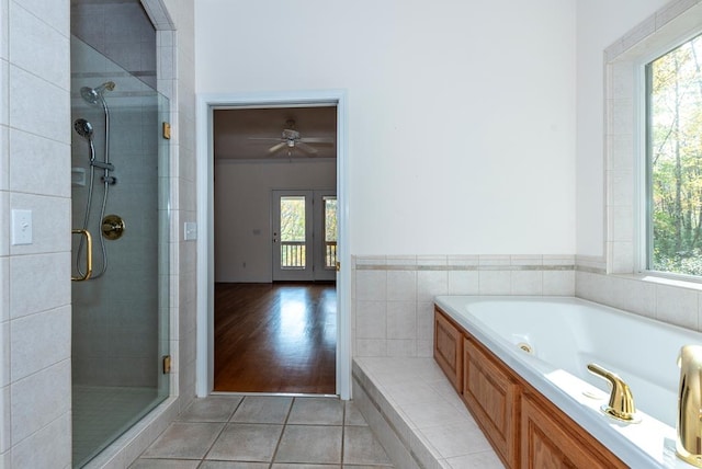 bathroom with shower with separate bathtub, a wealth of natural light, and hardwood / wood-style flooring