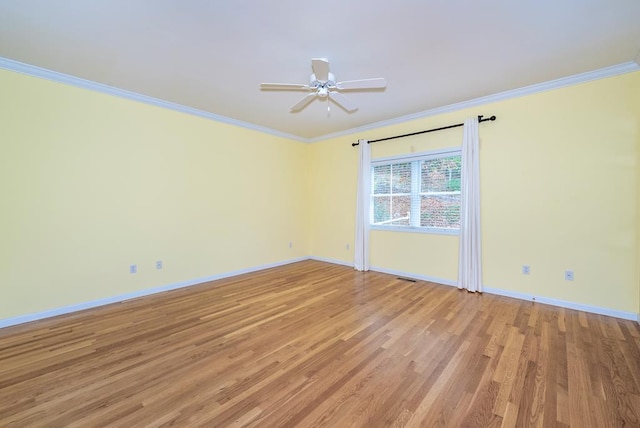 empty room featuring ceiling fan, ornamental molding, and light hardwood / wood-style flooring