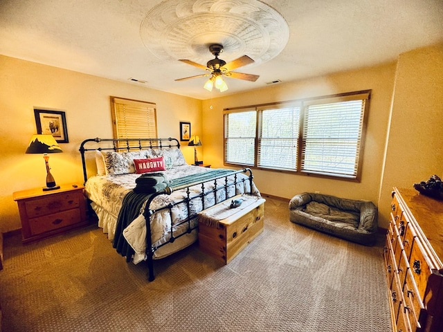 bedroom featuring ceiling fan, carpet, and a textured ceiling