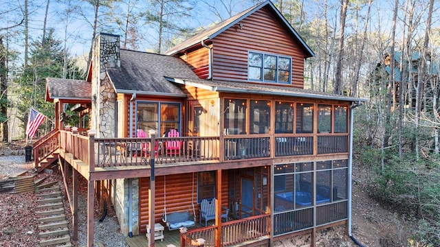 back of property with a sunroom