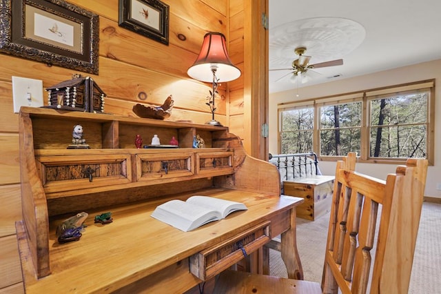 dining area with ceiling fan and light colored carpet