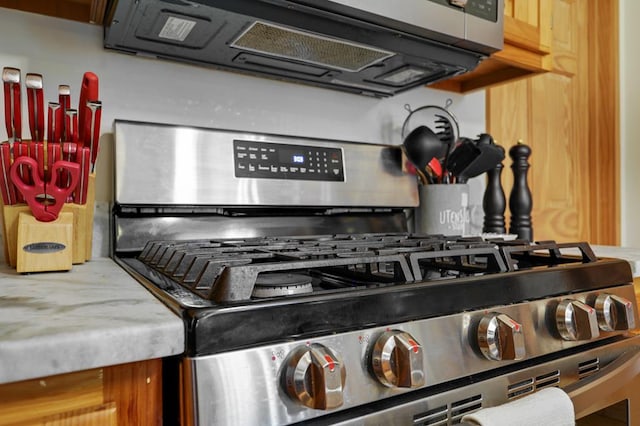 room details featuring stainless steel appliances and light stone counters