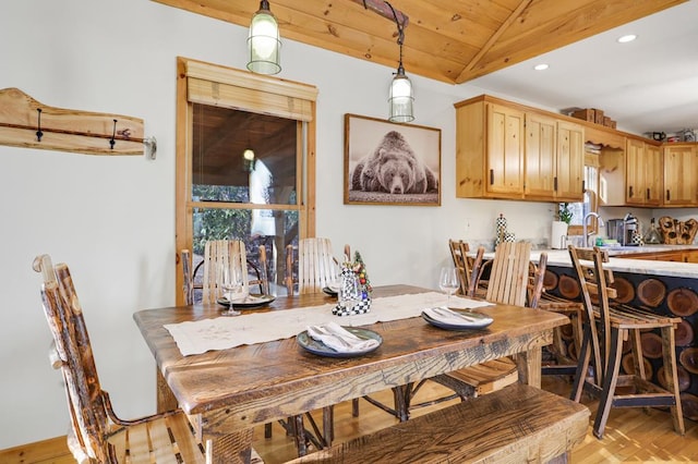 dining area with wooden ceiling, sink, light hardwood / wood-style floors, and lofted ceiling