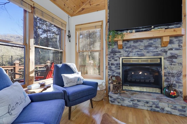 interior space featuring hardwood / wood-style flooring, vaulted ceiling, and a fireplace