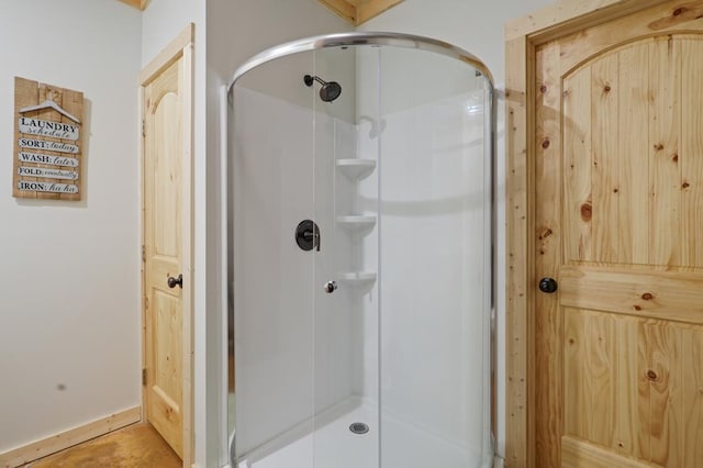 bathroom with a shower with door