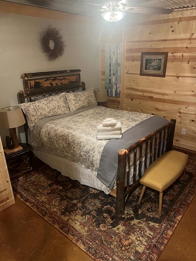 bedroom featuring wood walls