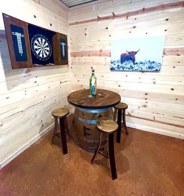 dining space featuring wooden walls