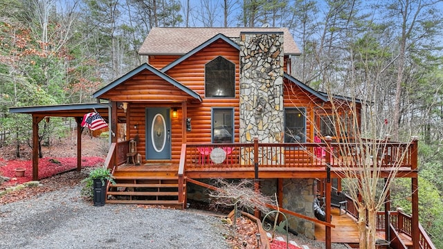 log-style house with a wooden deck