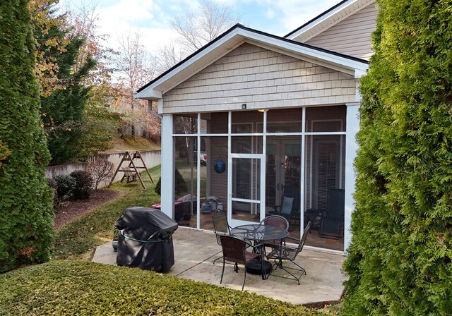 back of house featuring a patio and a sunroom