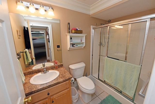 bathroom featuring crown molding, toilet, tile patterned floors, and a shower with shower door