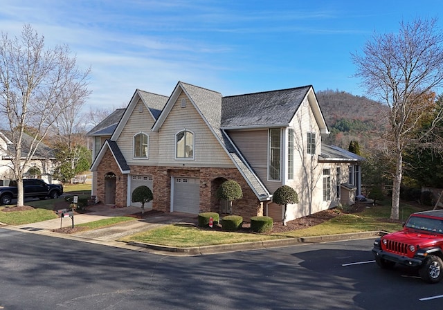 view of front of property with a garage and a mountain view