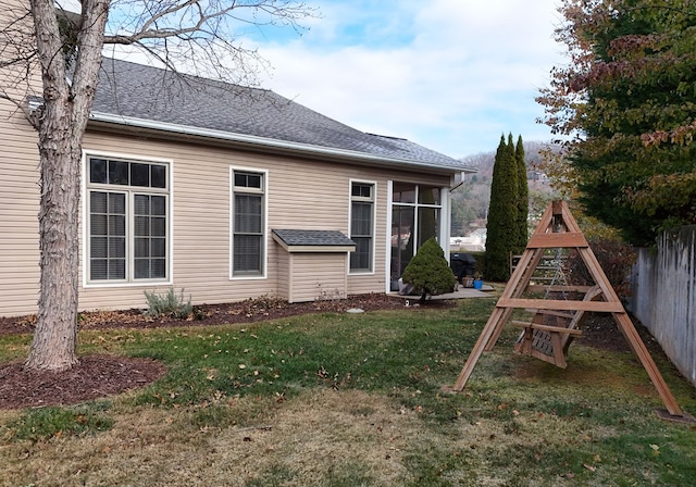 back of house with a lawn