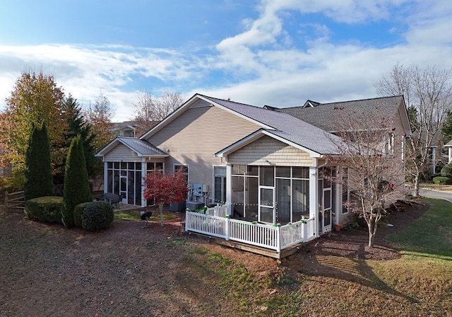 back of property with a sunroom