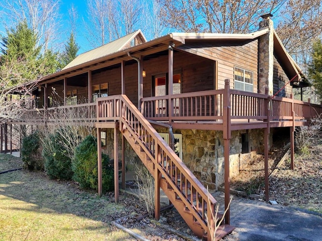 rear view of house featuring a deck