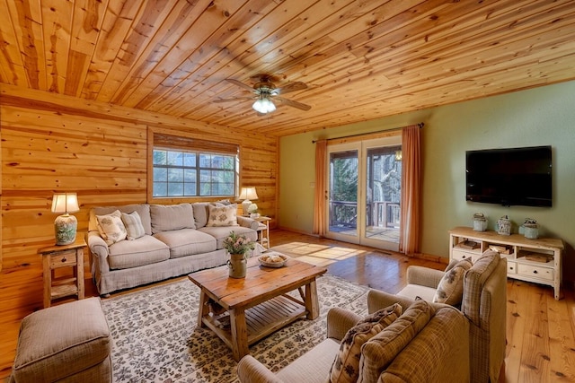 living room featuring ceiling fan, light hardwood / wood-style flooring, log walls, and wood ceiling