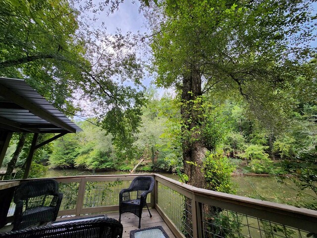 wooden deck featuring a water view