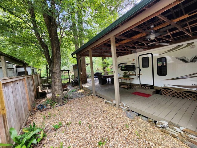 view of yard featuring ceiling fan and a deck