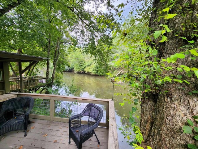 view of patio / terrace with a deck with water view