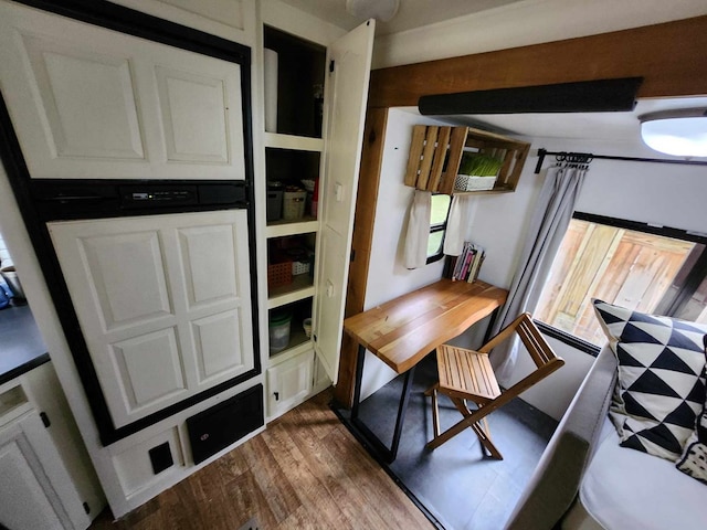 kitchen featuring dark wood-type flooring and white cabinets