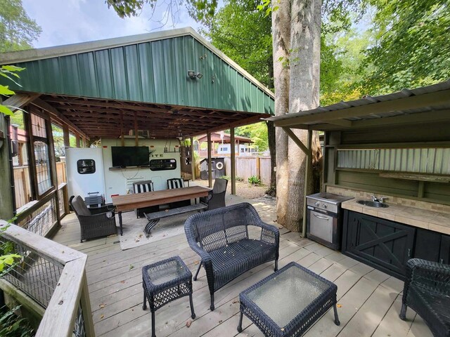 deck featuring area for grilling, outdoor lounge area, and sink