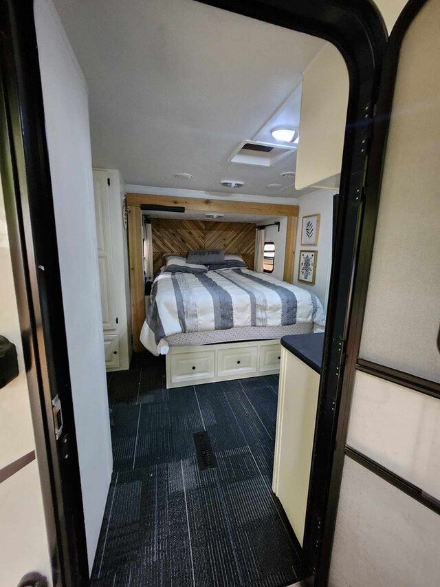 bedroom featuring dark colored carpet