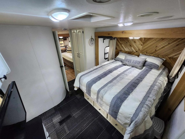 bedroom featuring wood walls