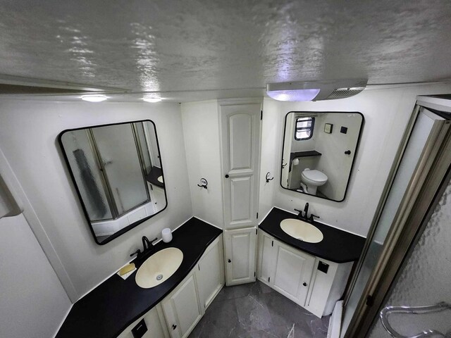 bathroom featuring a textured ceiling and vanity