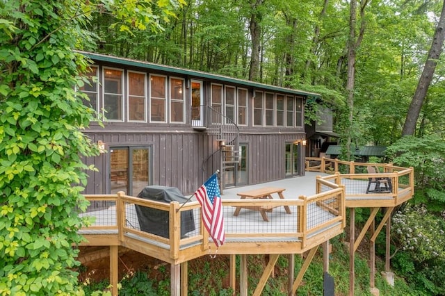 back of house featuring a wooden deck and an outdoor hangout area