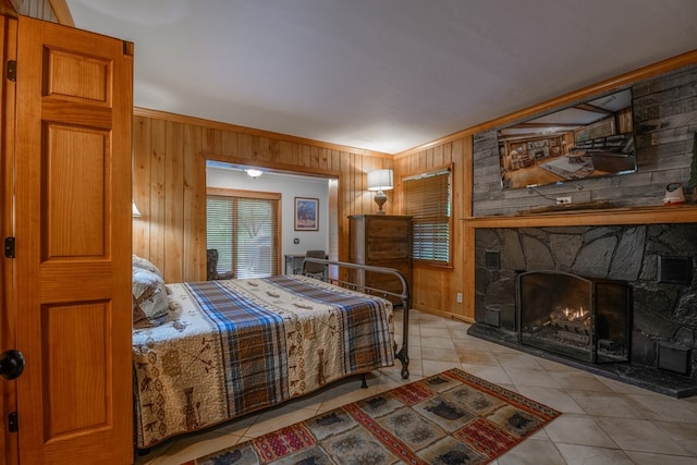 tiled bedroom with a stone fireplace and wooden walls