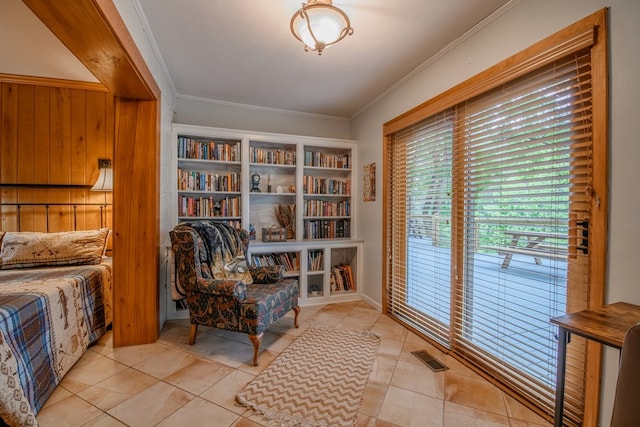 interior space featuring built in shelves, ornamental molding, and light tile floors