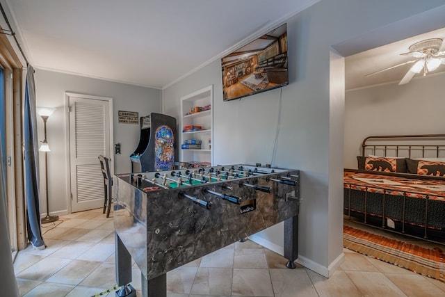 interior space with built in features, ceiling fan, crown molding, and light tile floors