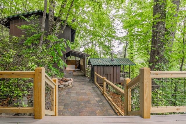 deck with a patio and a storage unit