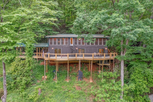 rear view of house featuring a deck