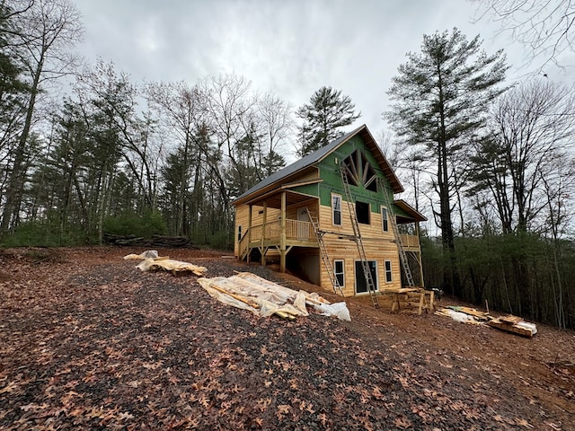 rear view of property featuring a deck