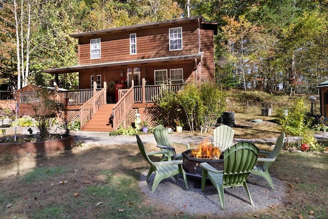 view of front of home with an outdoor fire pit and a deck