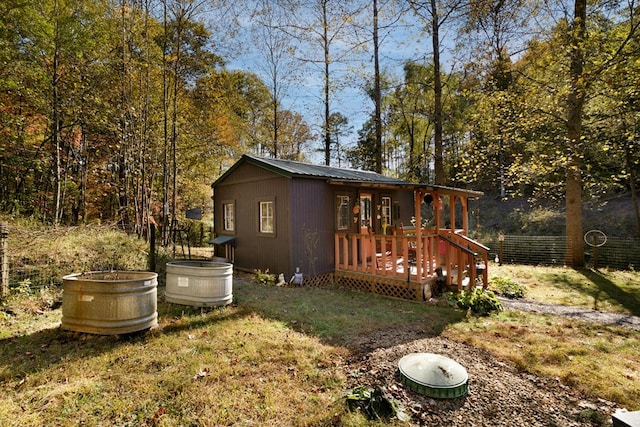 exterior space featuring a deck and a lawn