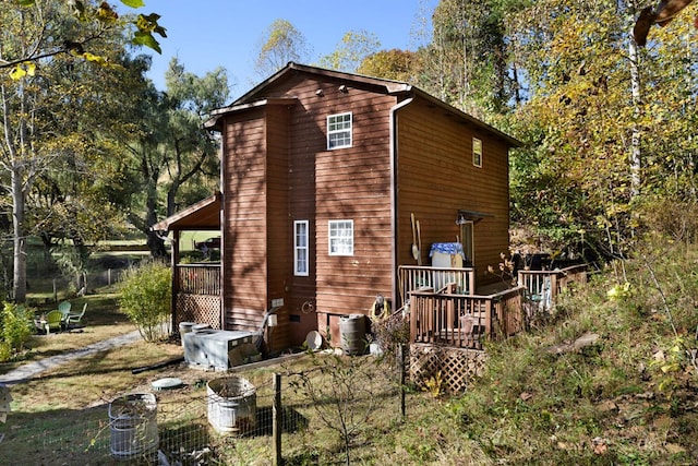 back of property featuring a deck and cooling unit