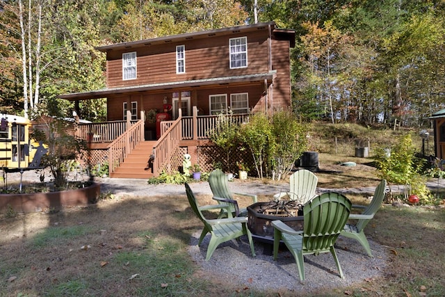 view of front facade with an outdoor fire pit and a deck