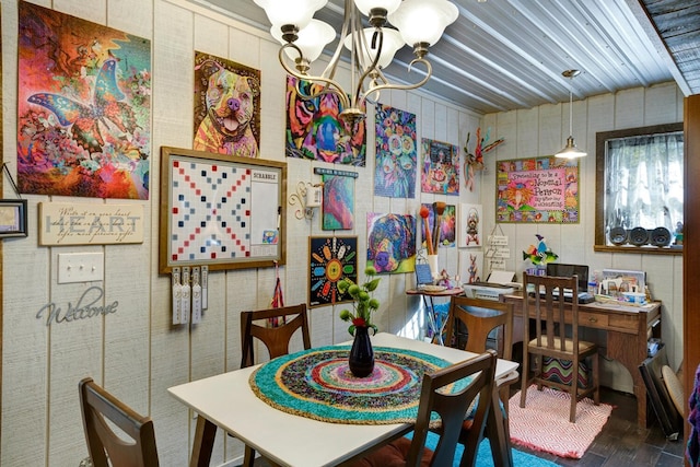 dining room featuring hardwood / wood-style flooring and an inviting chandelier