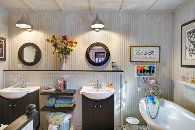 bathroom with vanity and a washtub