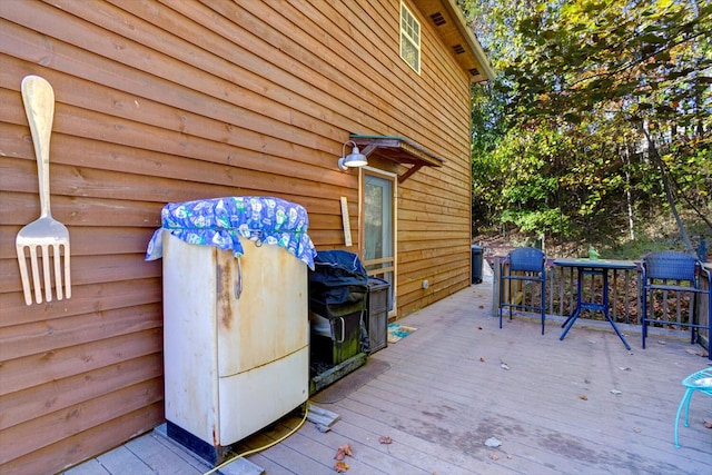 wooden terrace featuring a grill