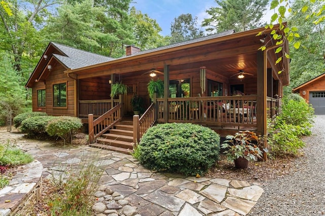 log home featuring a porch